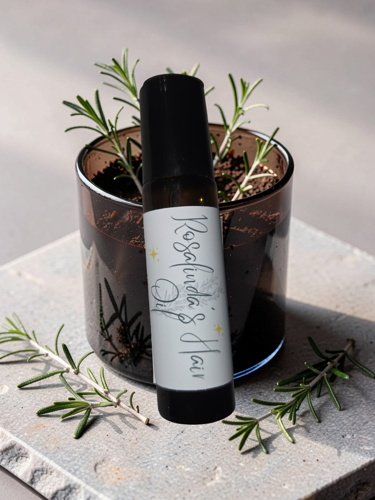 Rosemary Hair Oil bottle with rosemary sprigs